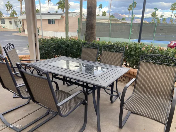 a view of a house with backyard sitting area and garden
