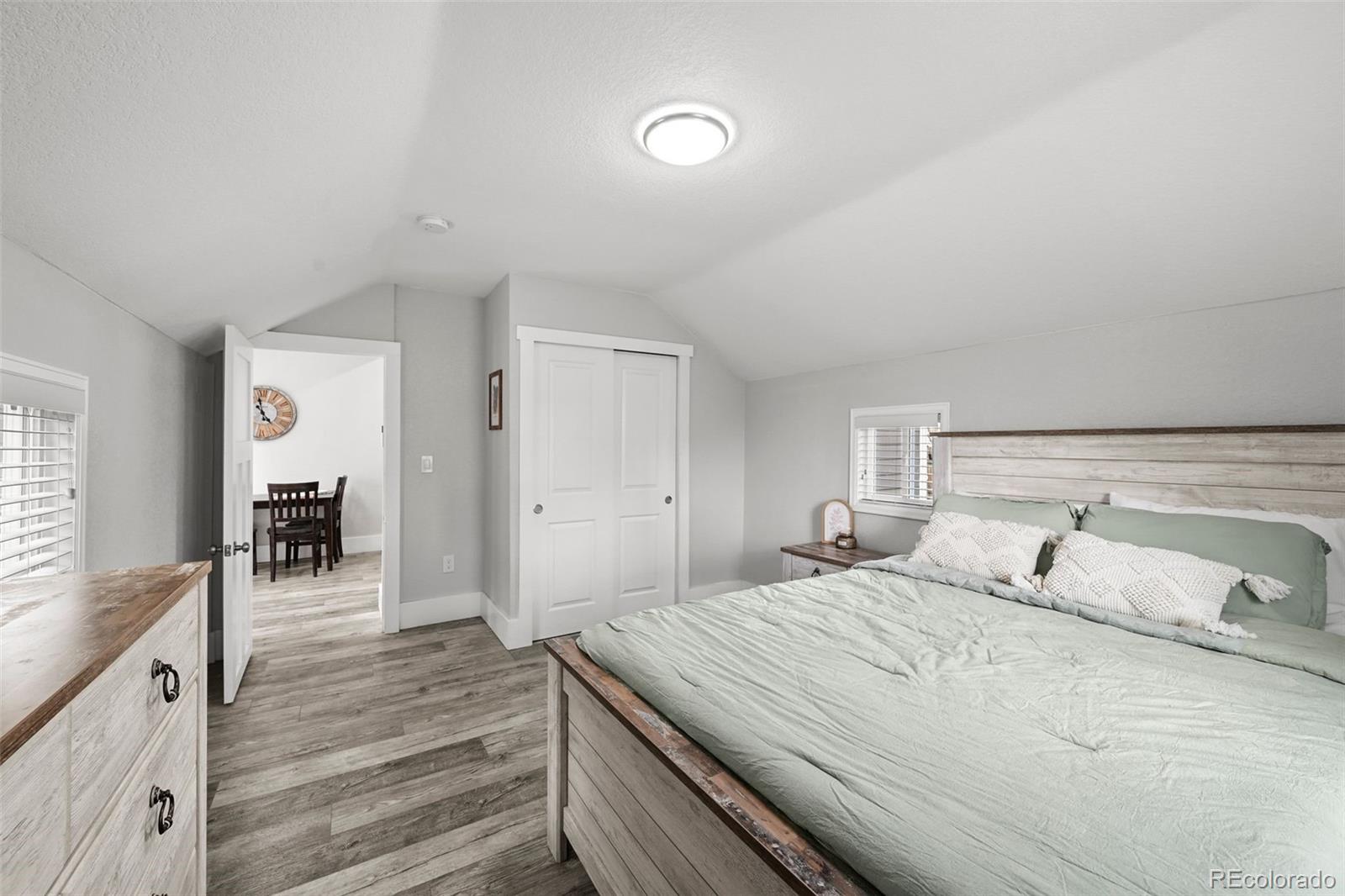 800 South Krameria Street Denver, CO 80224 - Photo 13 of 32 a bedroom with a bed and a flat tv screen on dresser