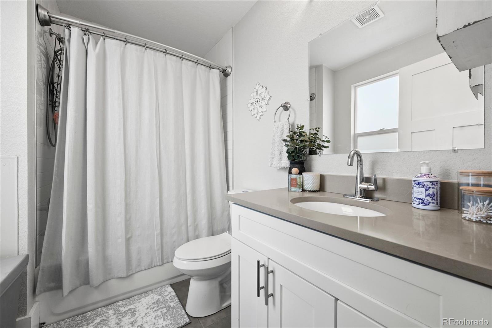 800 South Krameria Street Denver, CO 80224 - Photo 14 of 32 a bathroom with a granite countertop sink and a mirror