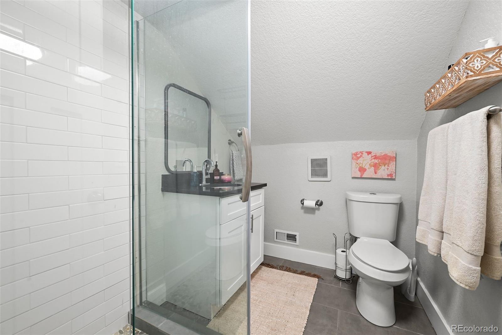 800 South Krameria Street Denver, CO 80224 - Photo 17 of 32 a bathroom with a toilet and a shower