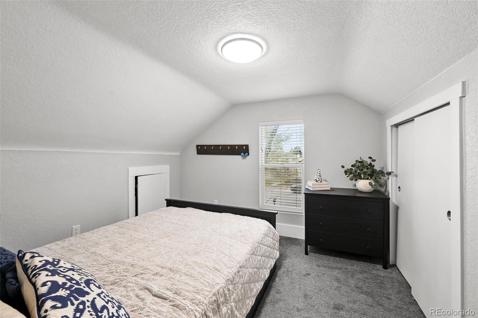 800 South Krameria Street Denver, CO 80224 - Photo 18 of 32 a bedroom with a bed and a dresser