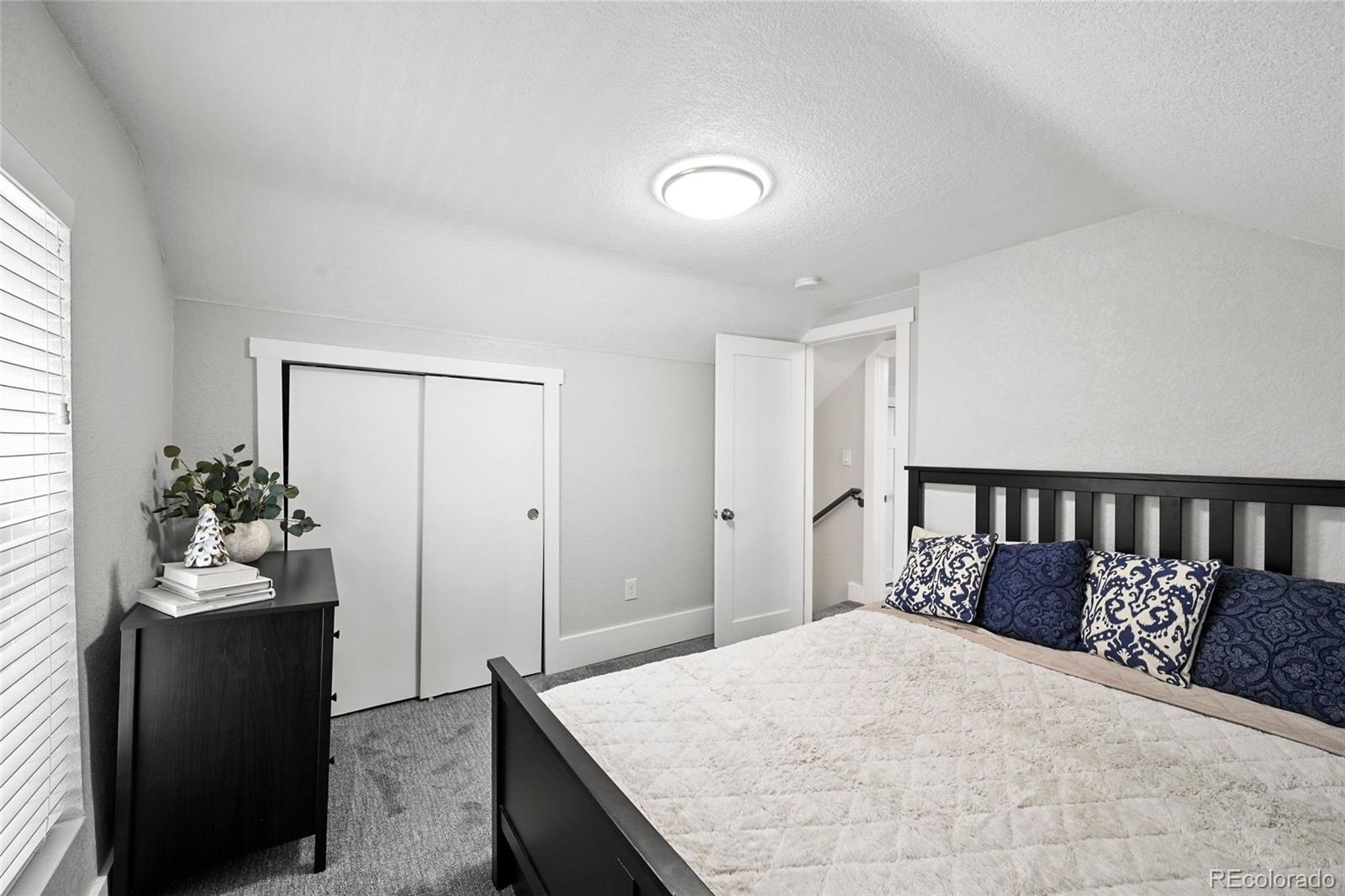 800 South Krameria Street Denver, CO 80224 - Photo 19 of 32 a bed room with a bed and a potted plant