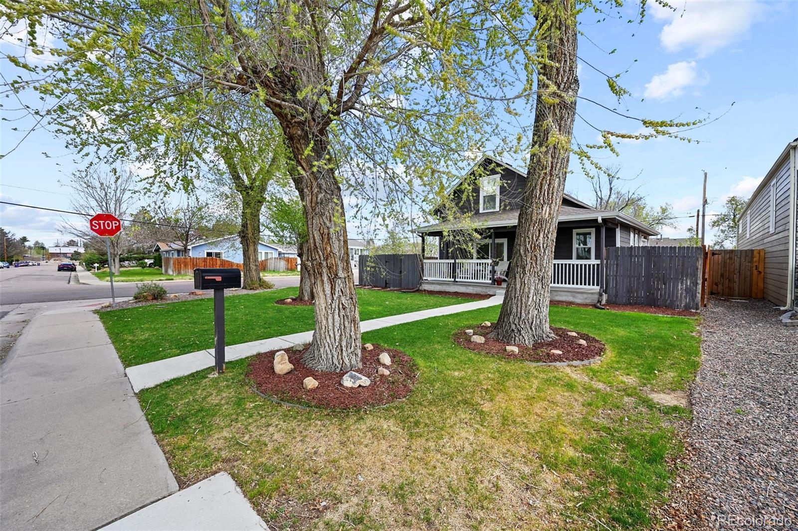 800 South Krameria Street Denver, CO 80224 - Photo 25 of 32 a front view of a house with a yard and tree