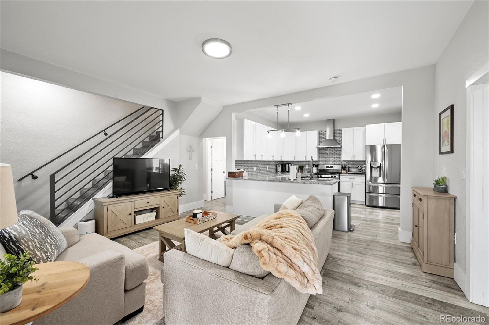 800 South Krameria Street Denver, CO 80224 - Photo 4 of 32 a living room with couches and kitchen view with wooden floor