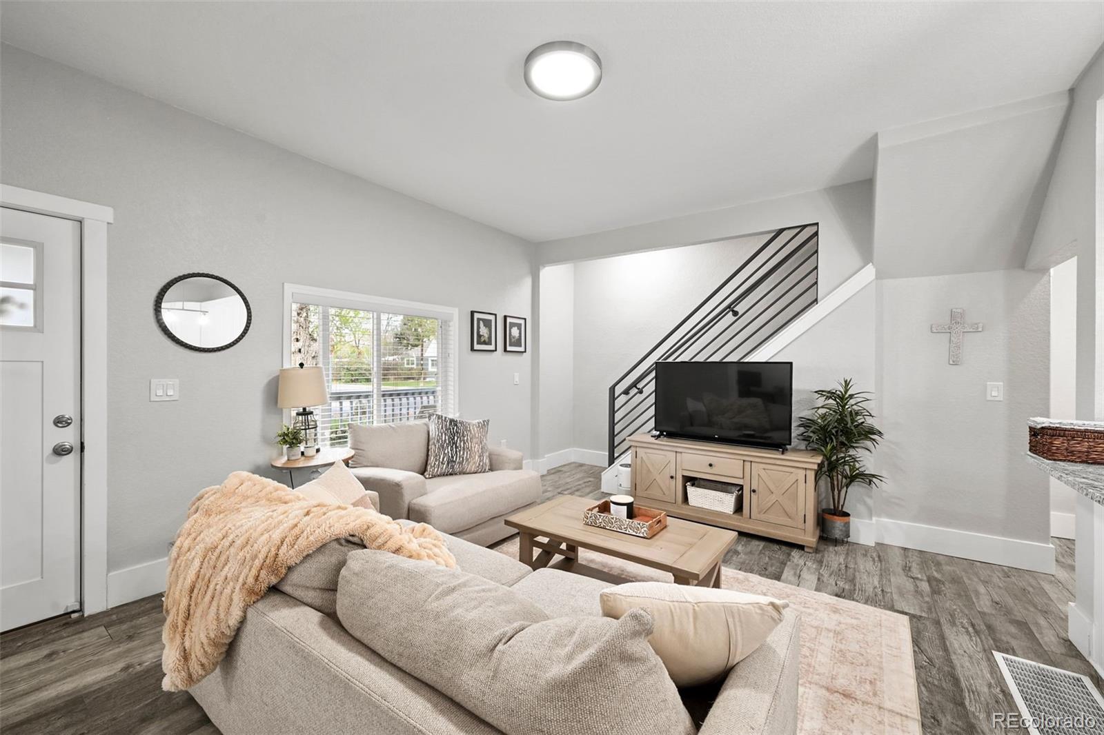 800 South Krameria Street Denver, CO 80224 - Photo 5 of 32 a living room with furniture and a flat screen tv