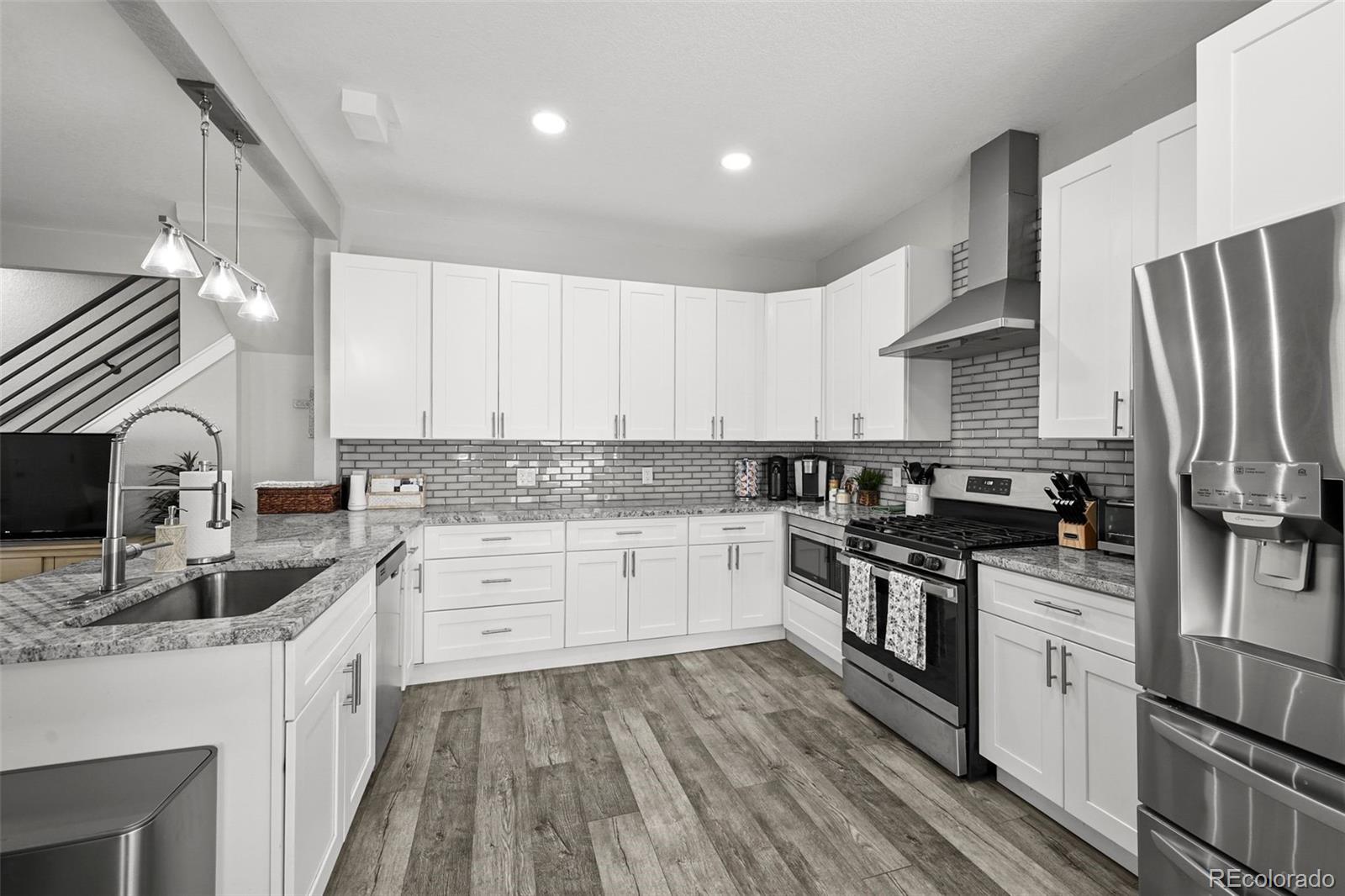 800 South Krameria Street Denver, CO 80224 - Photo 7 of 32 a kitchen with granite countertop a sink stove and refrigerator