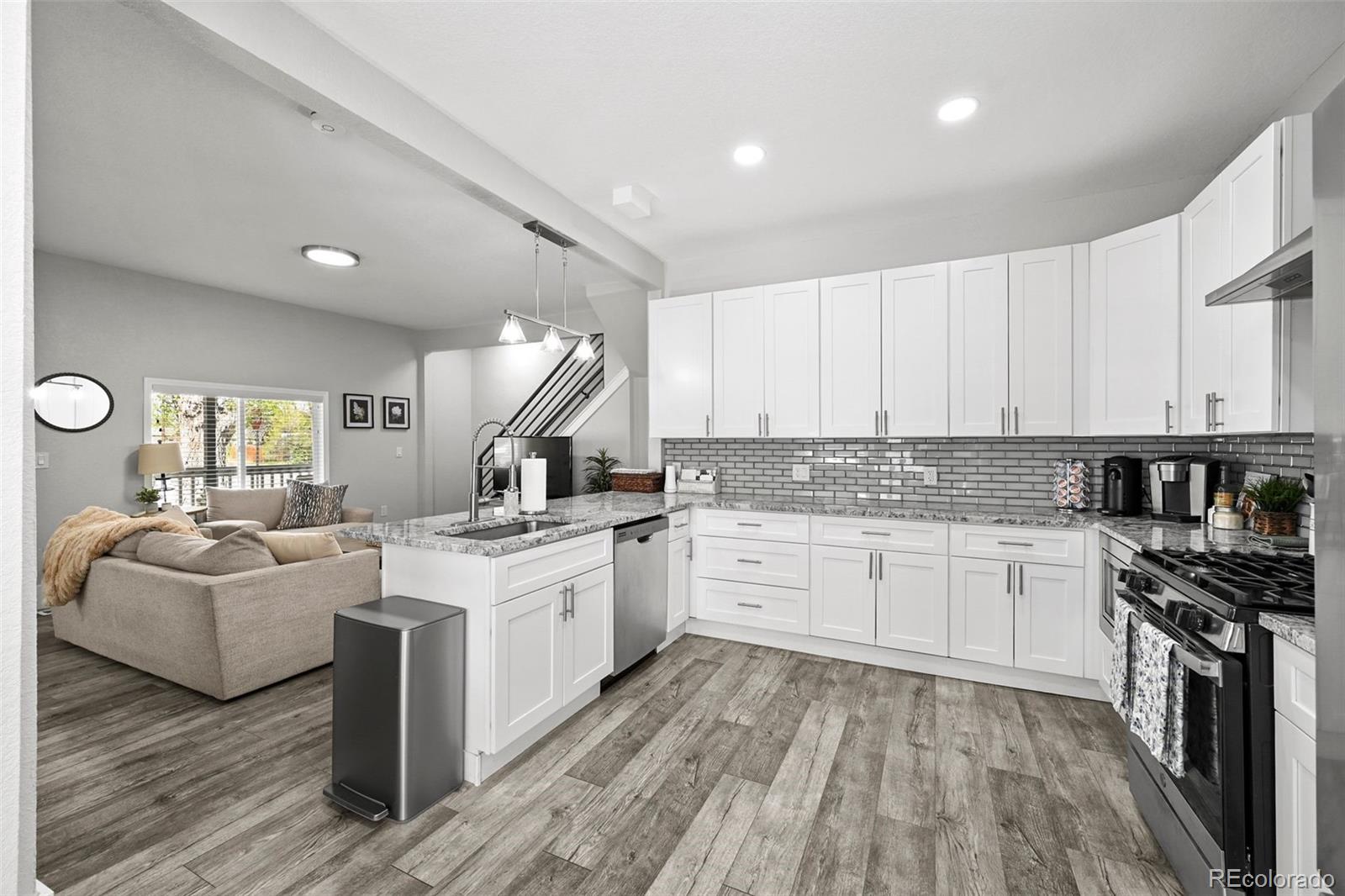 800 South Krameria Street Denver, CO 80224 - Photo 8 of 32 a kitchen with a sink stove and cabinets