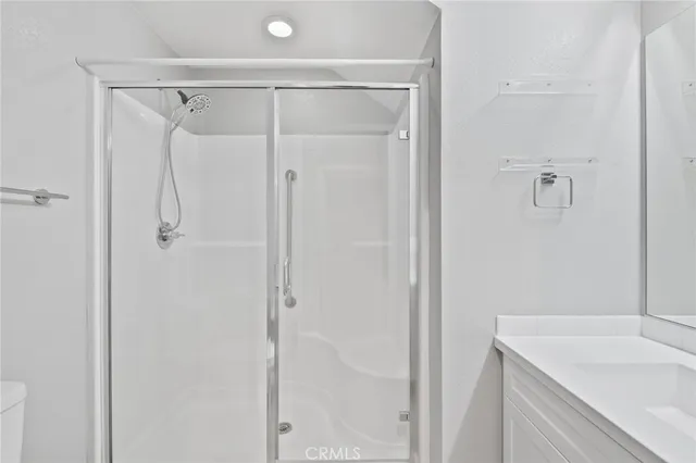 a bathroom with a shower sink and vanity