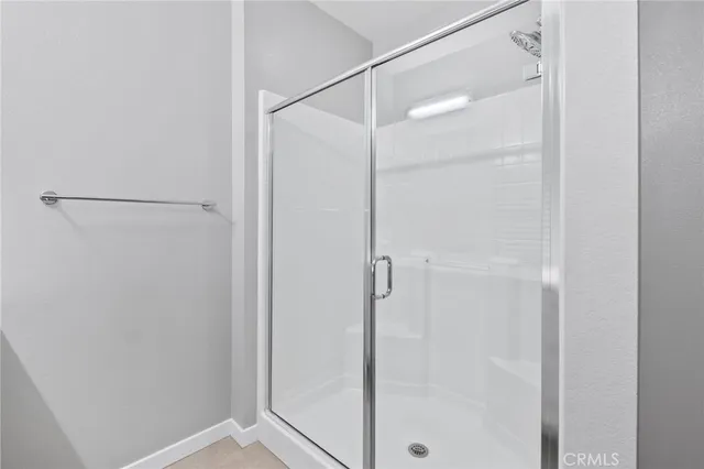 a bathroom with a double vanity sink a mirror and a shower