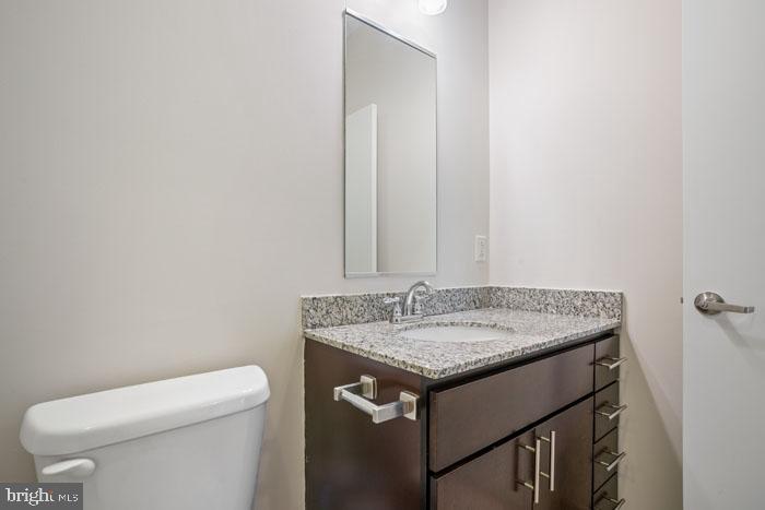 131 Bridge Street, Unit 2B22402 Phoenixville, PA 19460 - Photo 101 of 104 a bathroom with a granite countertop sink and a toilet