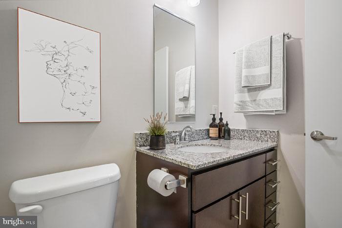 131 Bridge Street, Unit 2B22402 Phoenixville, PA 19460 - Photo 104 of 104 a bathroom with a granite countertop sink a toilet and a mirror