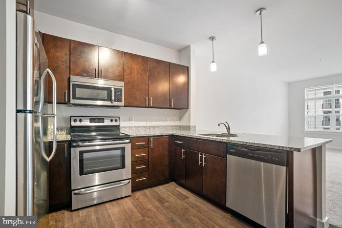 131 Bridge Street, Unit 2B22402 Phoenixville, PA 19460 - Photo 15 of 104 a kitchen with stainless steel appliances granite countertop a sink and stove top oven