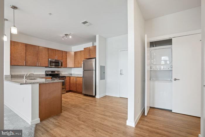 131 Bridge Street, Unit 2B22402 Phoenixville, PA 19460 - Photo 83 of 104 a kitchen with stainless steel appliances granite countertop a refrigerator and a stove top oven
