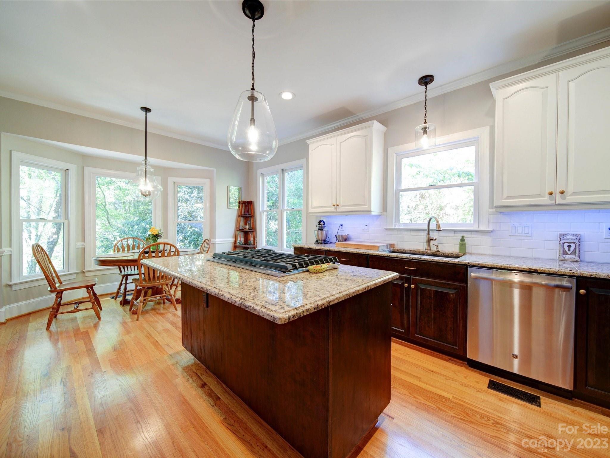 536 Beacon Knoll Lane Fort Mill, SC 29708 - Photo 8 of 45 a kitchen with kitchen island granite countertop a stove a sink a dining table and chairs
