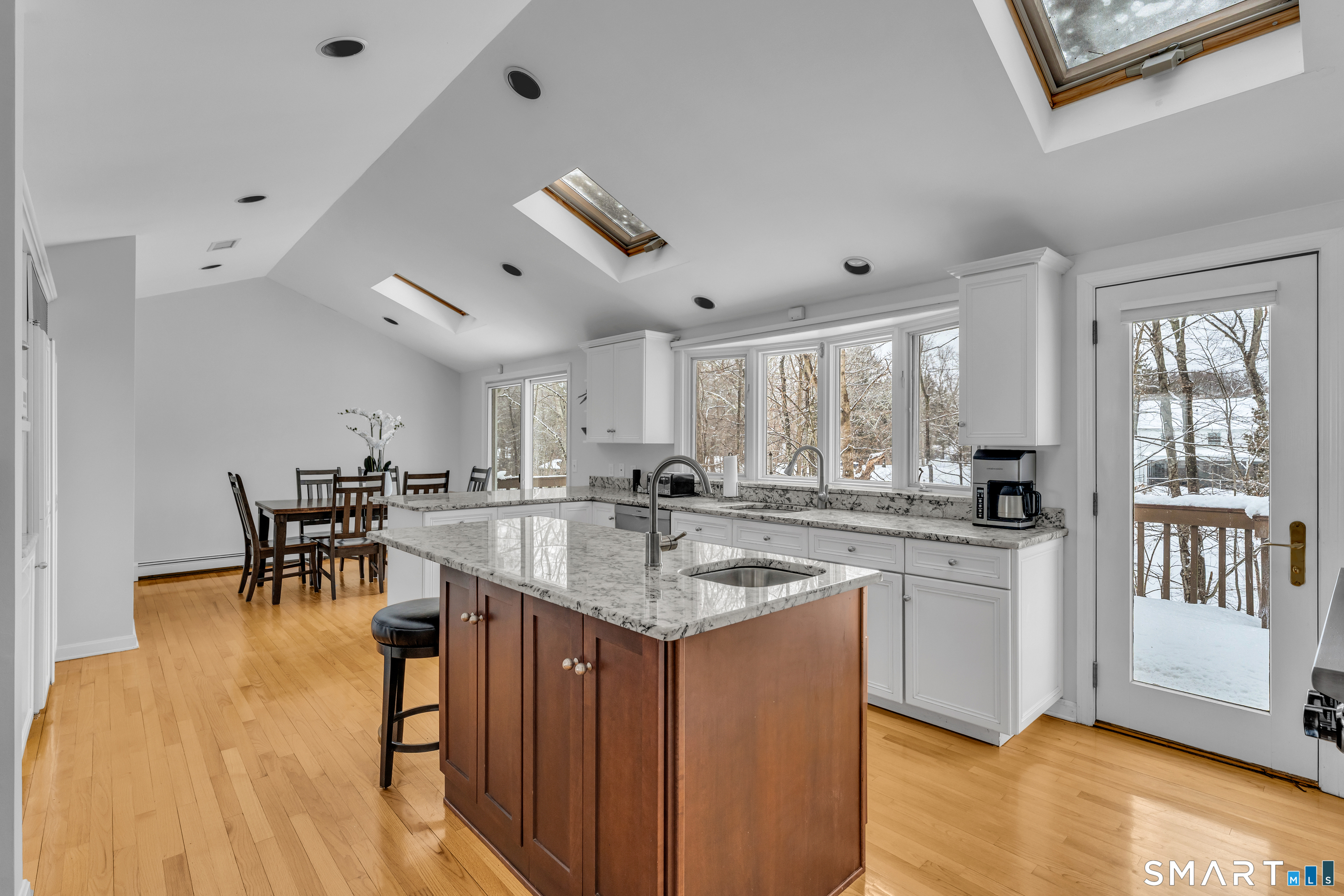 40 Hull Road Madison, CT 06443 - Photo 11 of 40 The eat-in kitchen is the heart of this home with vaulted ceilings and skylights giving this room more of an open feel.
