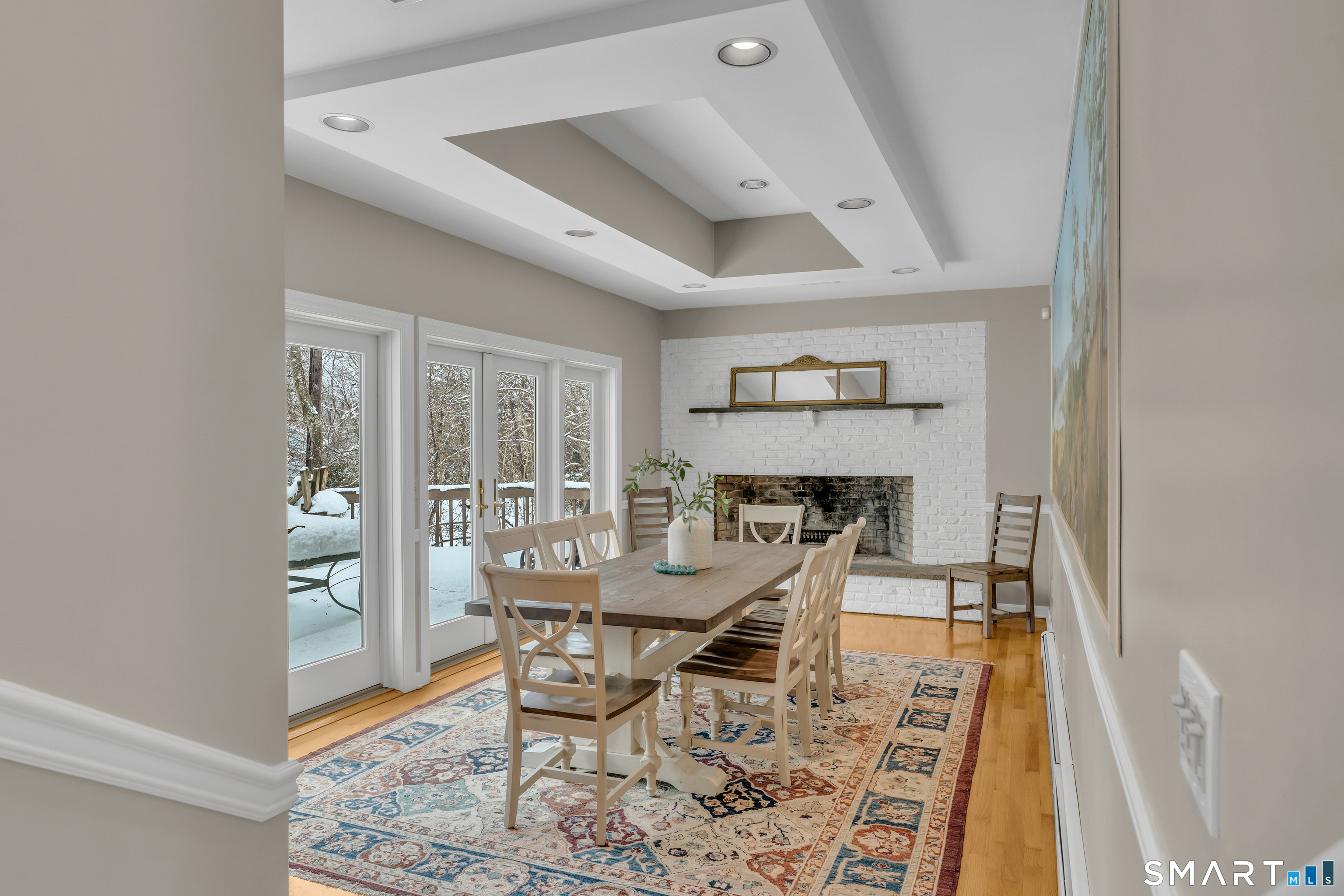 40 Hull Road Madison, CT 06443 - Photo 16 of 40 Just a couple of steps down to the dramatic dining room (or can be a main floor family room) with tray ceiling, large fireplace and incredible mural. French doors access the deck.