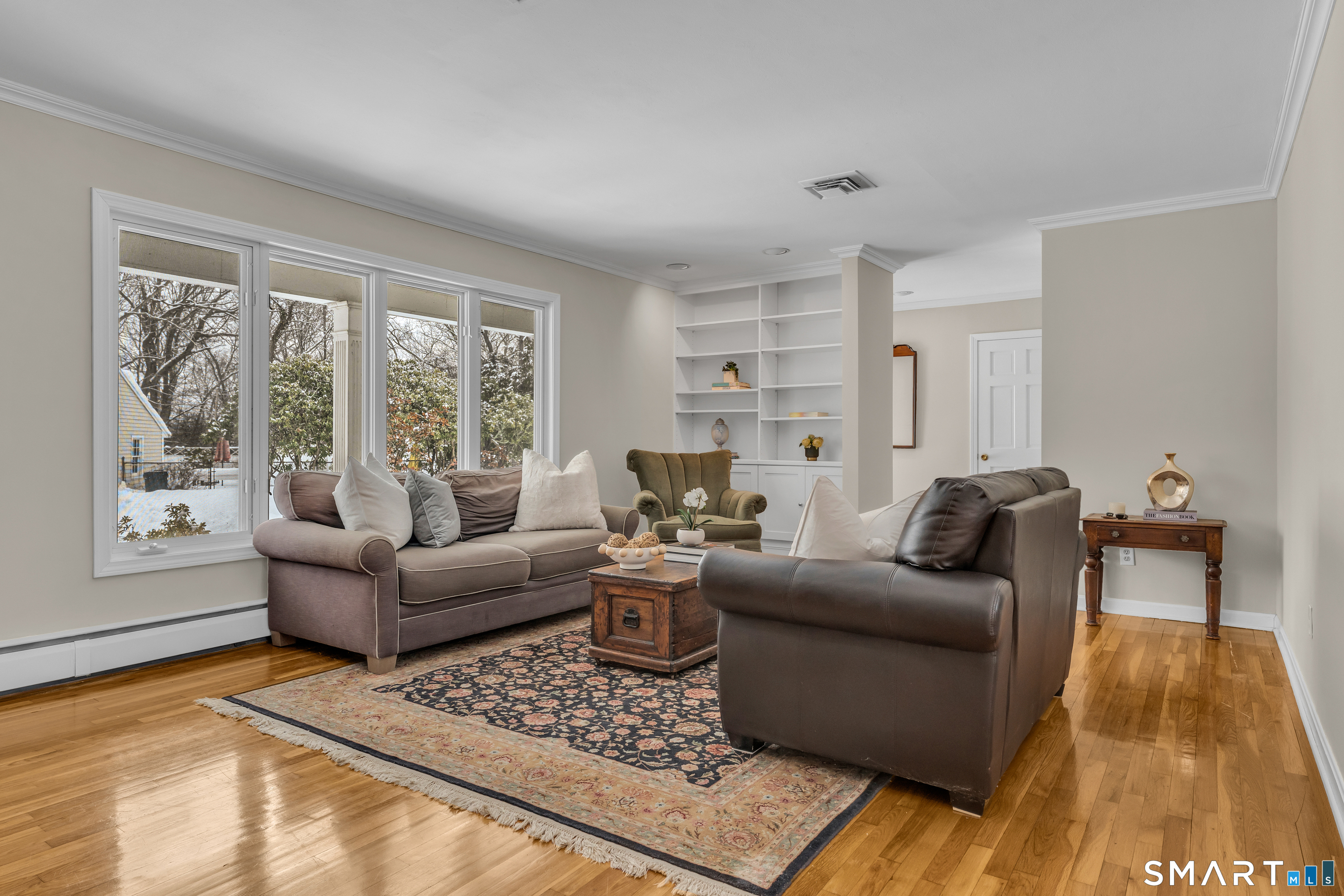 40 Hull Road Madison, CT 06443 - Photo 7 of 40 Huge bank of windows lets in lots of natural light. Built in bookshelves with storage below is a bonus.