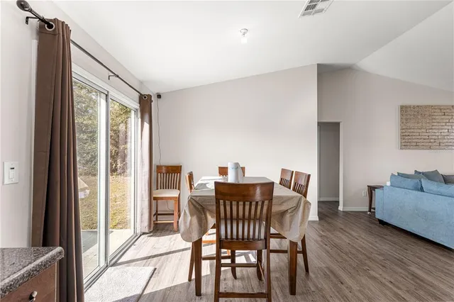 a dining room with furniture and wooden floor