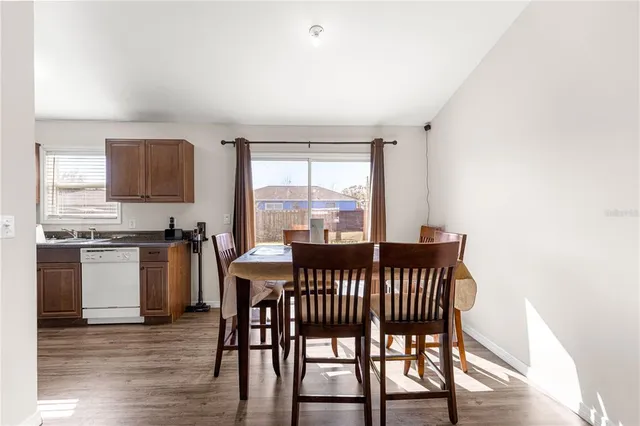 a view of a dining room with furniture window and wooden floor