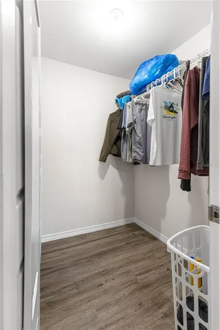 a view of walk in closet with clothes and shoes
