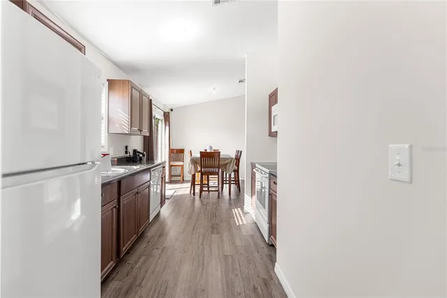 a kitchen with granite countertop white cabinets and stainless steel appliances