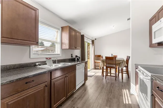 a kitchen with a table chairs stove and cabinets