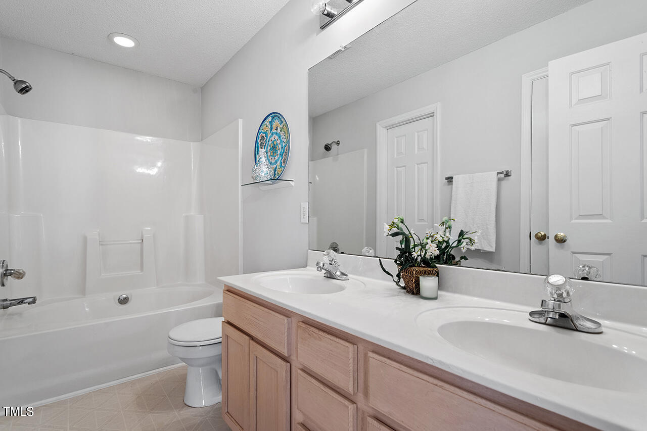 3907 Rim Court Raleigh, NC 27616 - Photo 25 of 30 a bathroom with a sink and a mirror