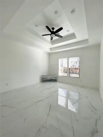 a view of an empty room with a fireplace and a window
