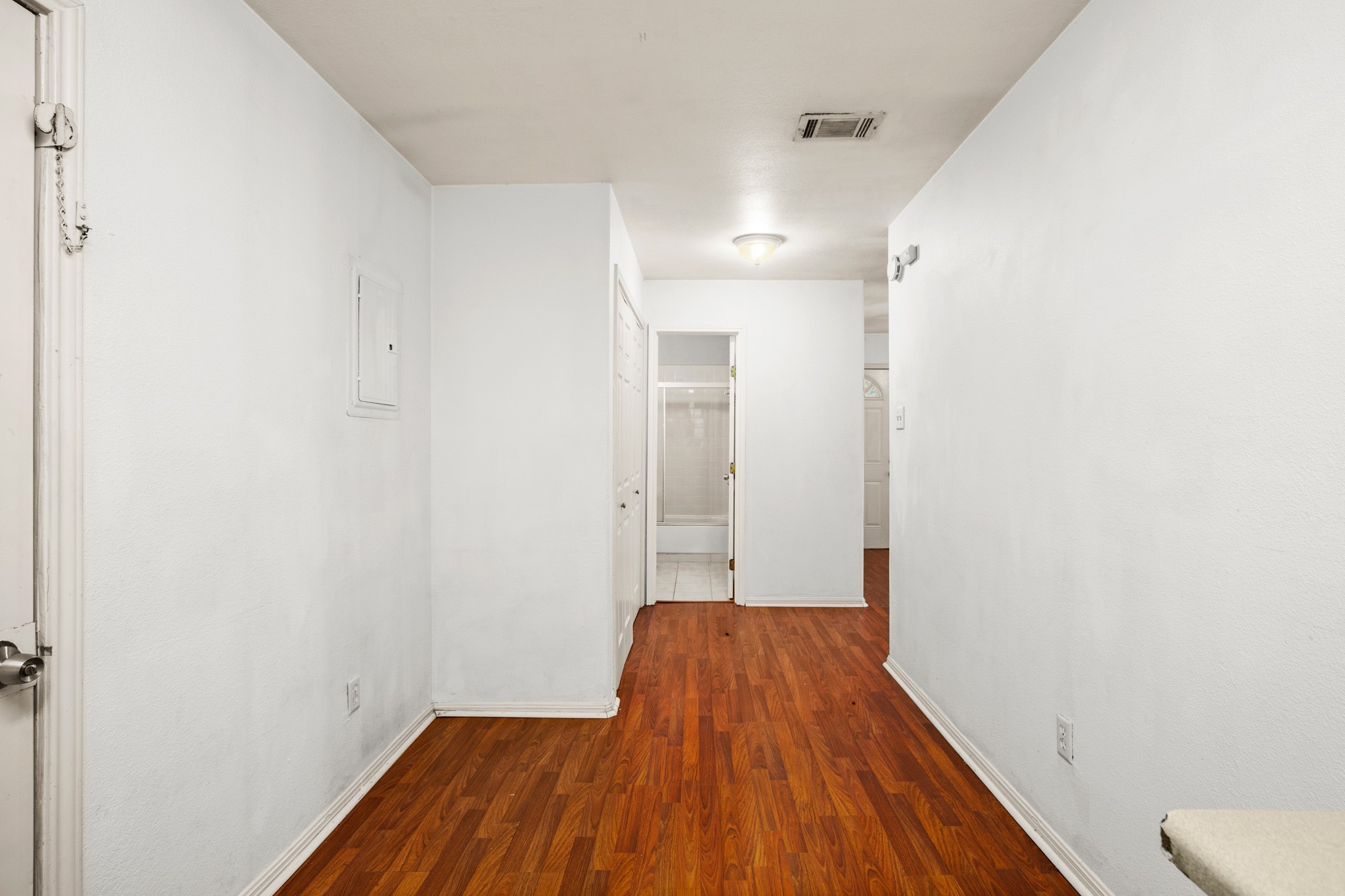 2610 East 3rd Street, Unit B Austin, TX 78702 - Photo 6 of 14 a view of a bathroom with wooden floor and a sink