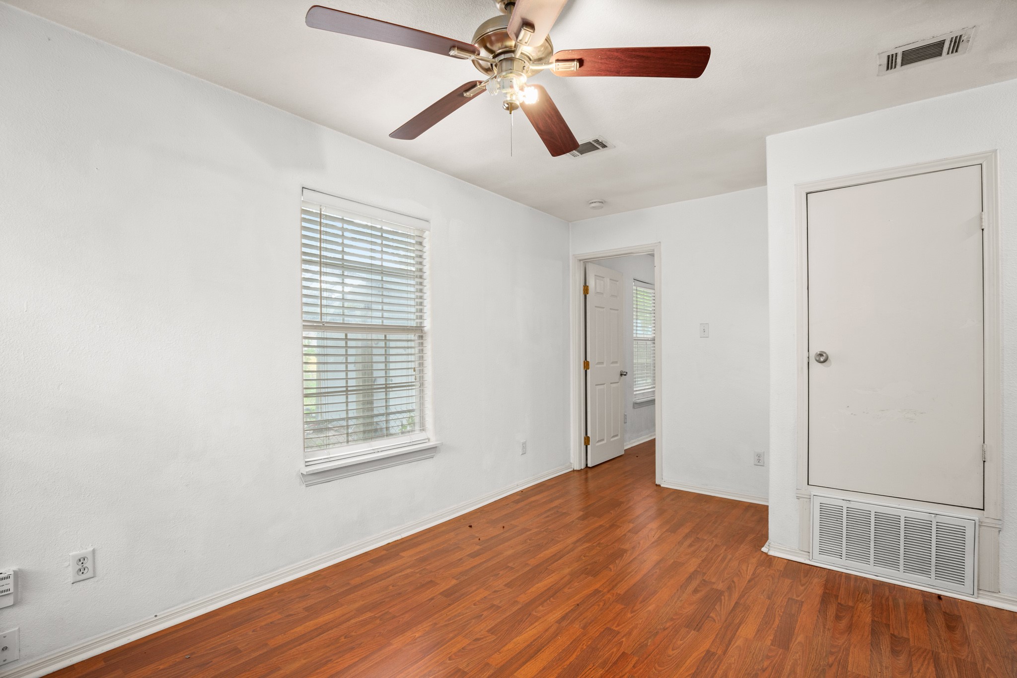 2610 East 3rd Street, Unit B Austin, TX 78702 - Photo 7 of 14 wooden floor in an empty room with a window