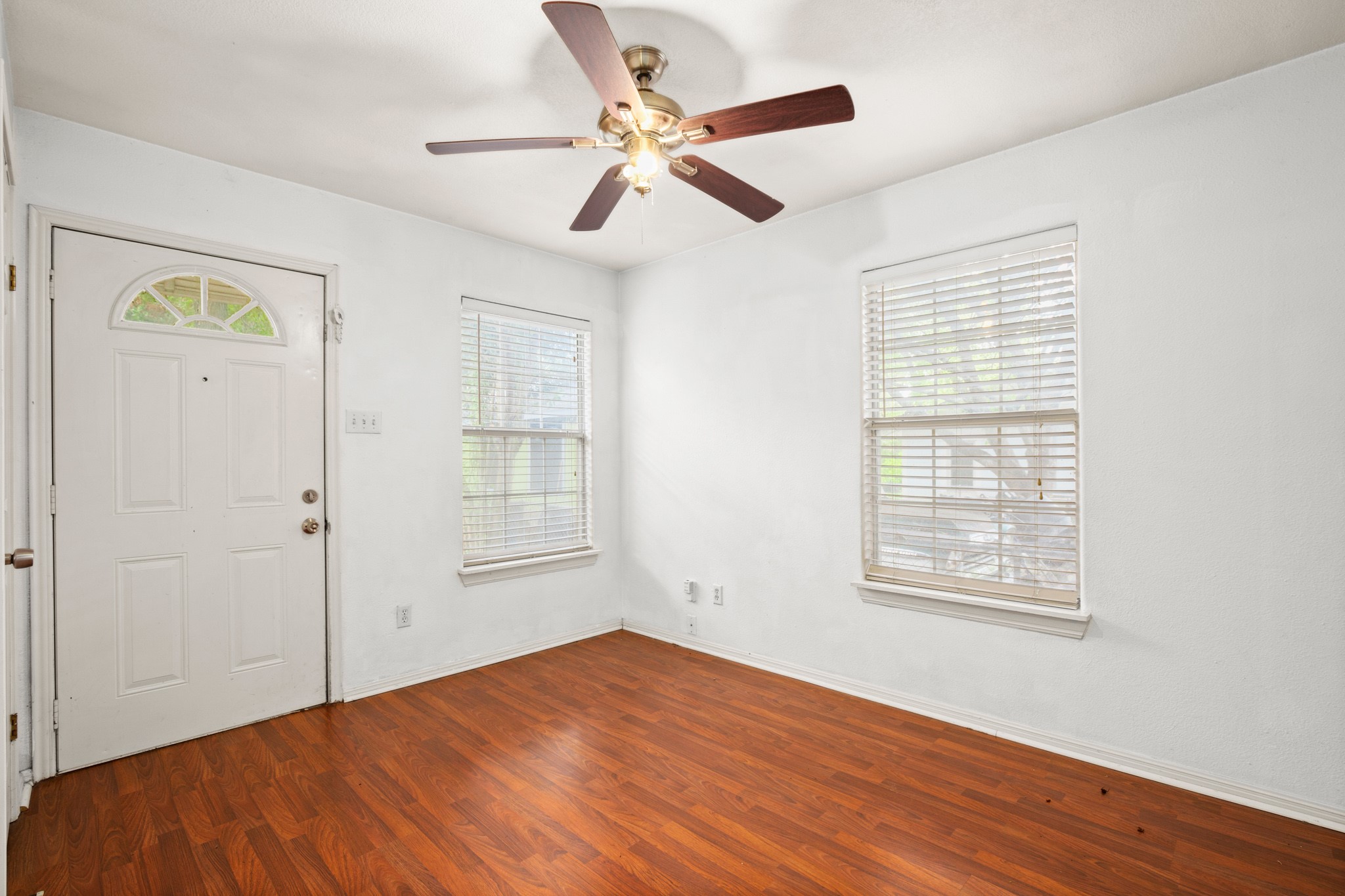 2610 East 3rd Street, Unit B Austin, TX 78702 - Photo 8 of 14 a view of empty room with wooden floor and fan