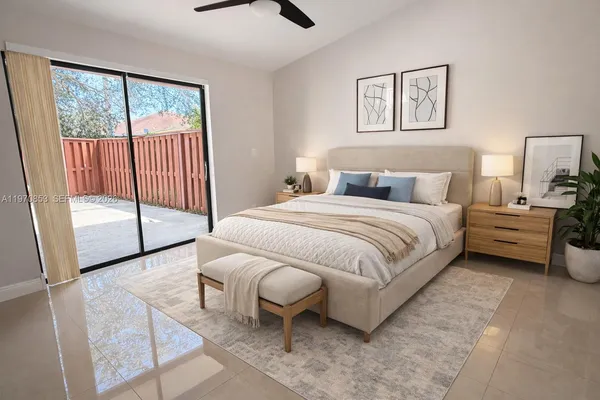 a bedroom with a bed and a large window