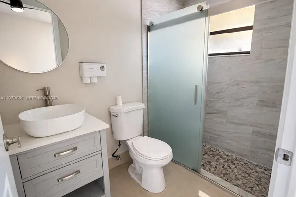 a bathroom with a toilet a sink and a mirror