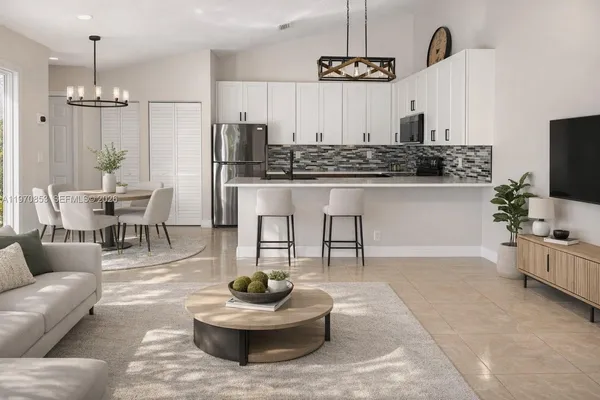 a living room with furniture and a chandelier