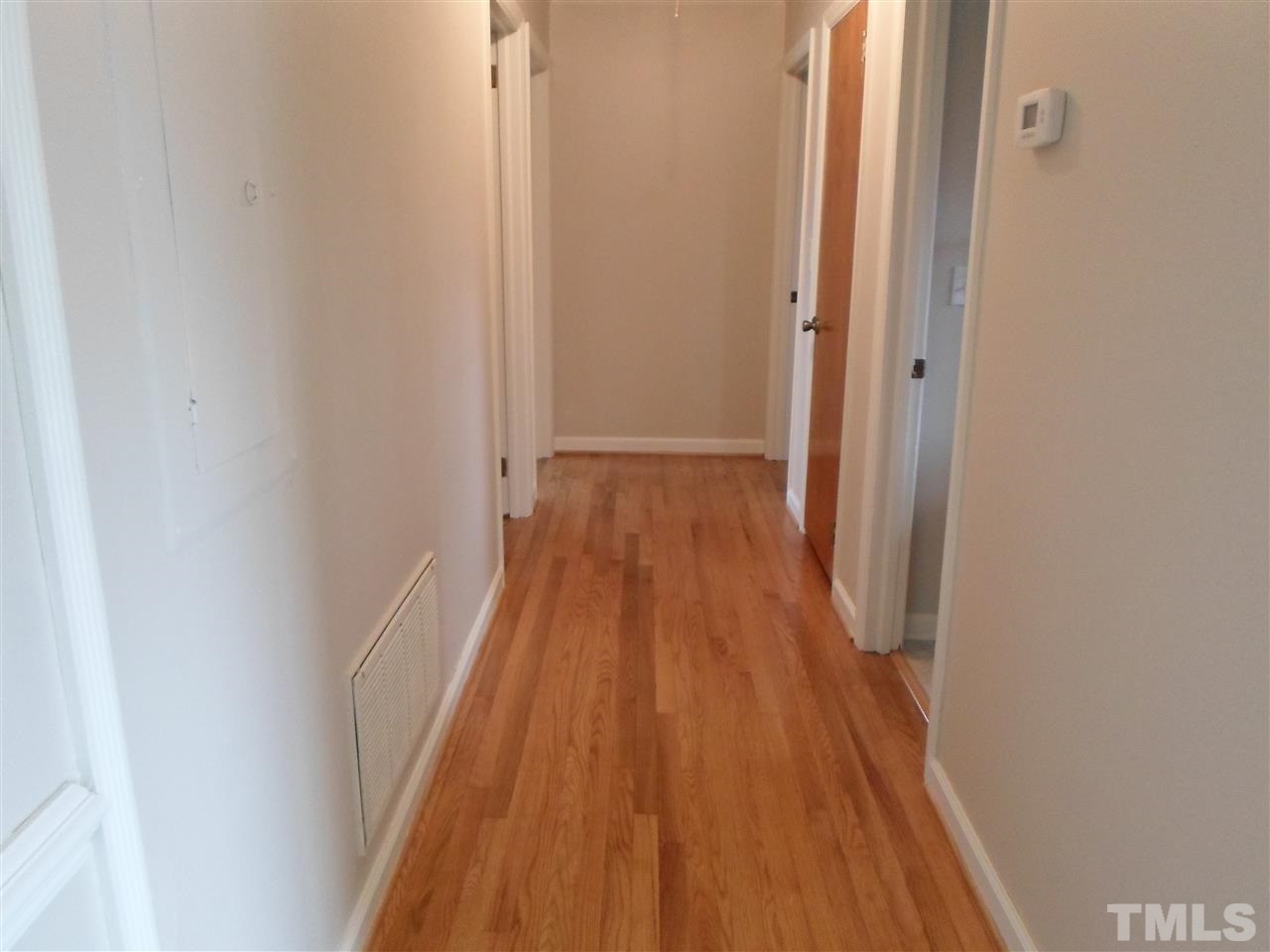10913 Poole Road Wendell, NC 27591 - Photo 9 of 22 Nice wide hallway and another look at the gorgeous hardwood floors!