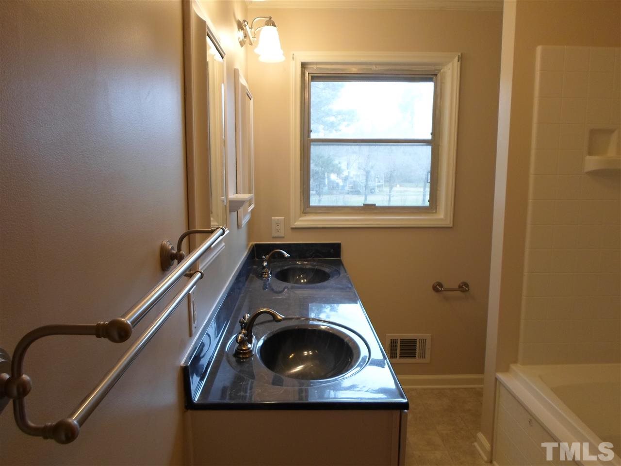 10913 Poole Road Wendell, NC 27591 - Photo 10 of 22 Hall bath has double vanities and jetted tub.