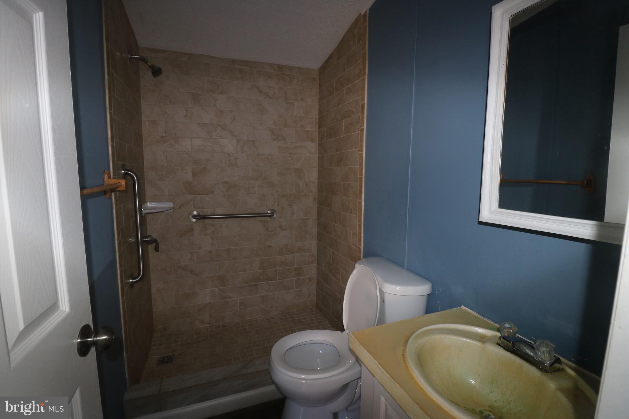 116 Roundup Road Middle River, MD 21220 - Photo 11 of 16 a white toilet sitting next to a bathroom sink