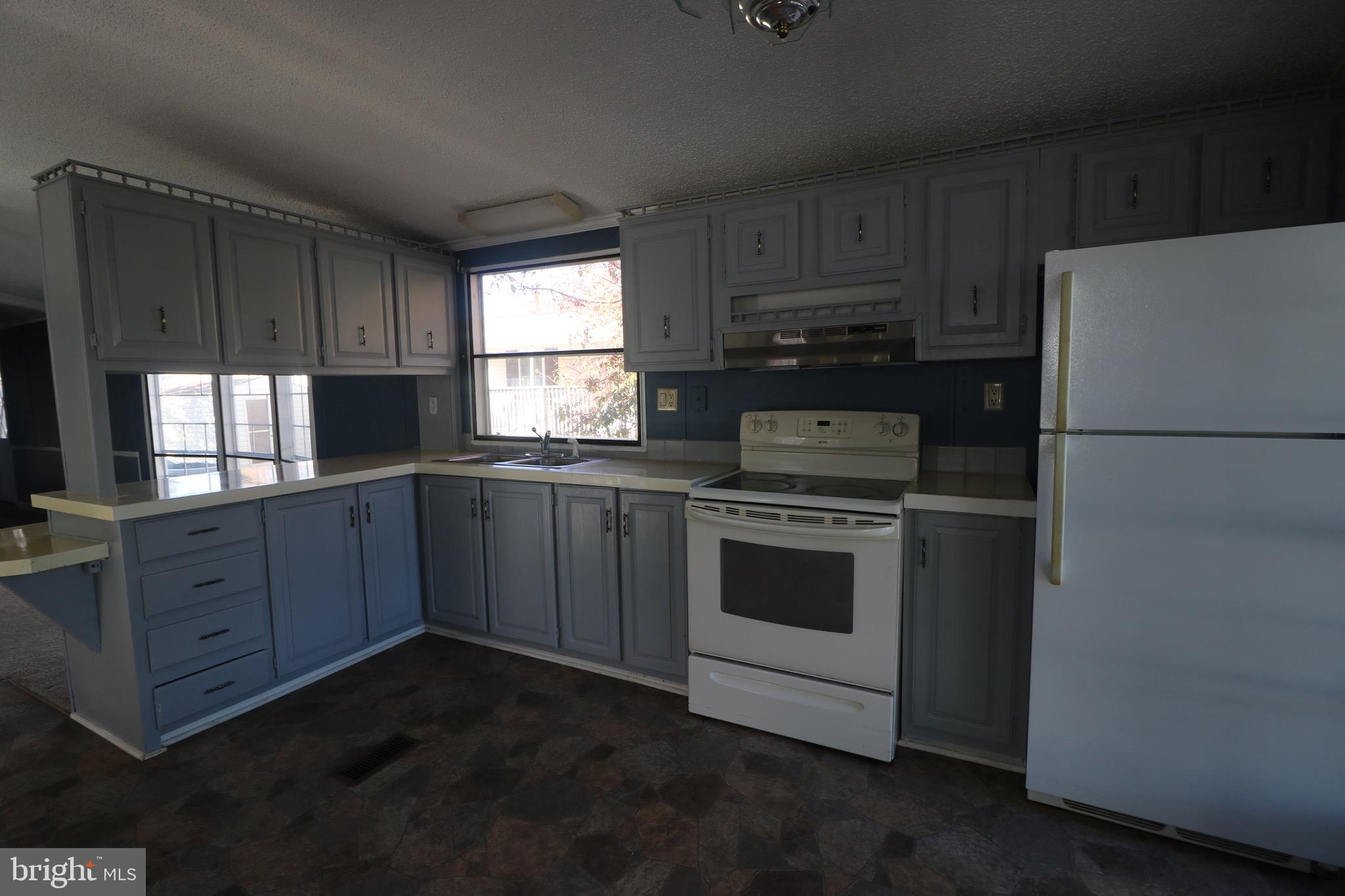 116 Roundup Road Middle River, MD 21220 - Photo 5 of 16 a kitchen with a white stove top oven and refrigerator