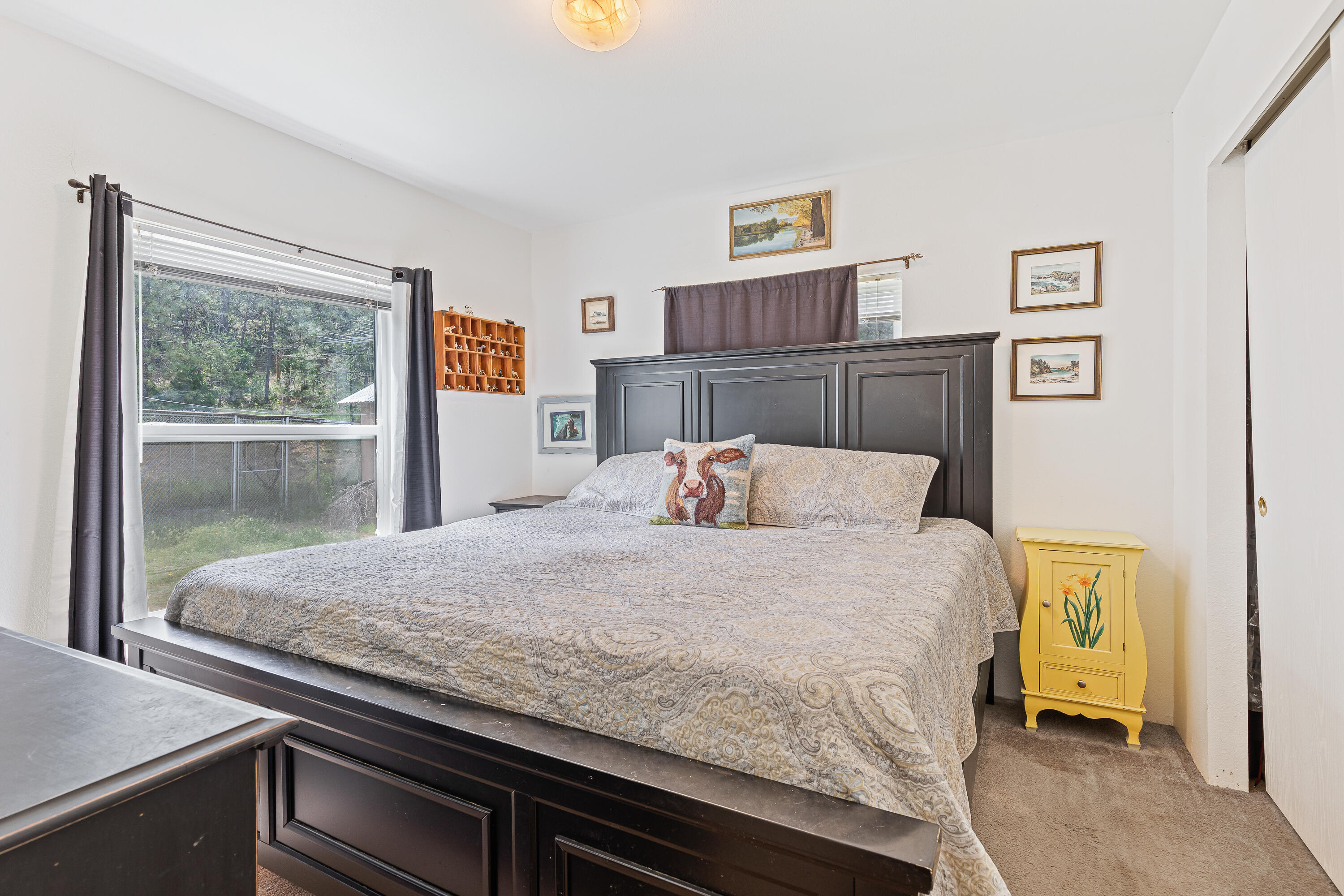 13721 Upper Applegate Road Jacksonville, OR 97530 - Photo 11 of 26 a bedroom with a bed and wooden floor