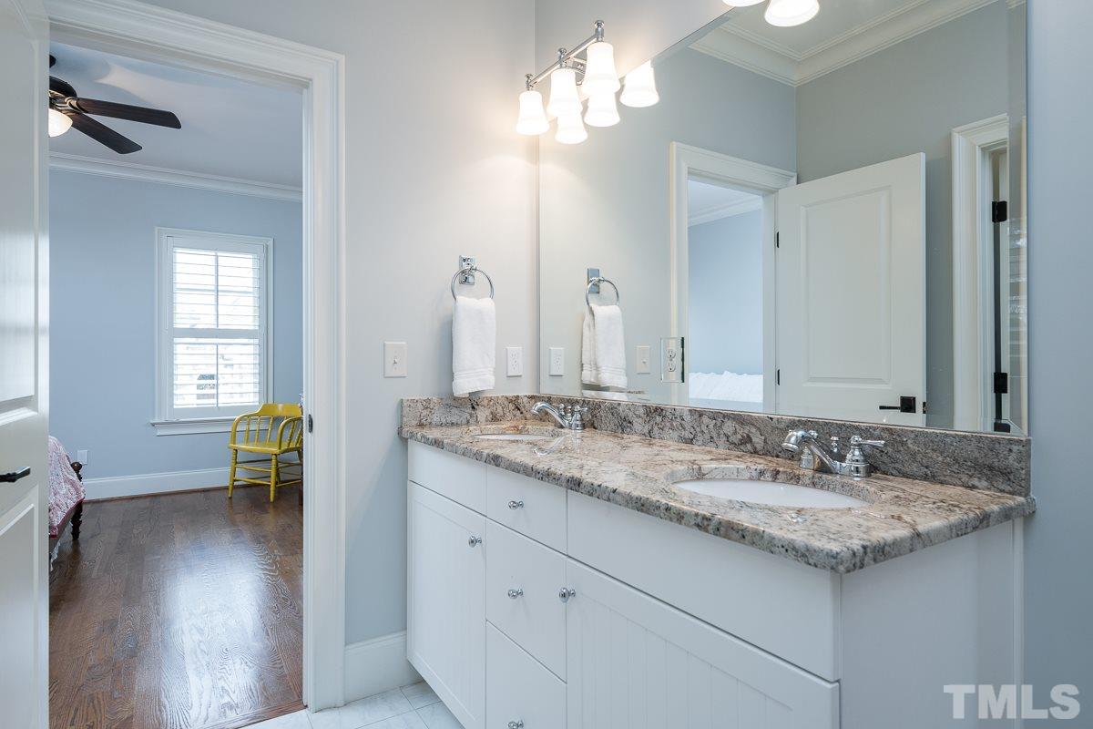 540 Guilford Circle Raleigh, NC 27608 - Photo 18 of 25 a bathroom with a granite countertop sink and a mirror