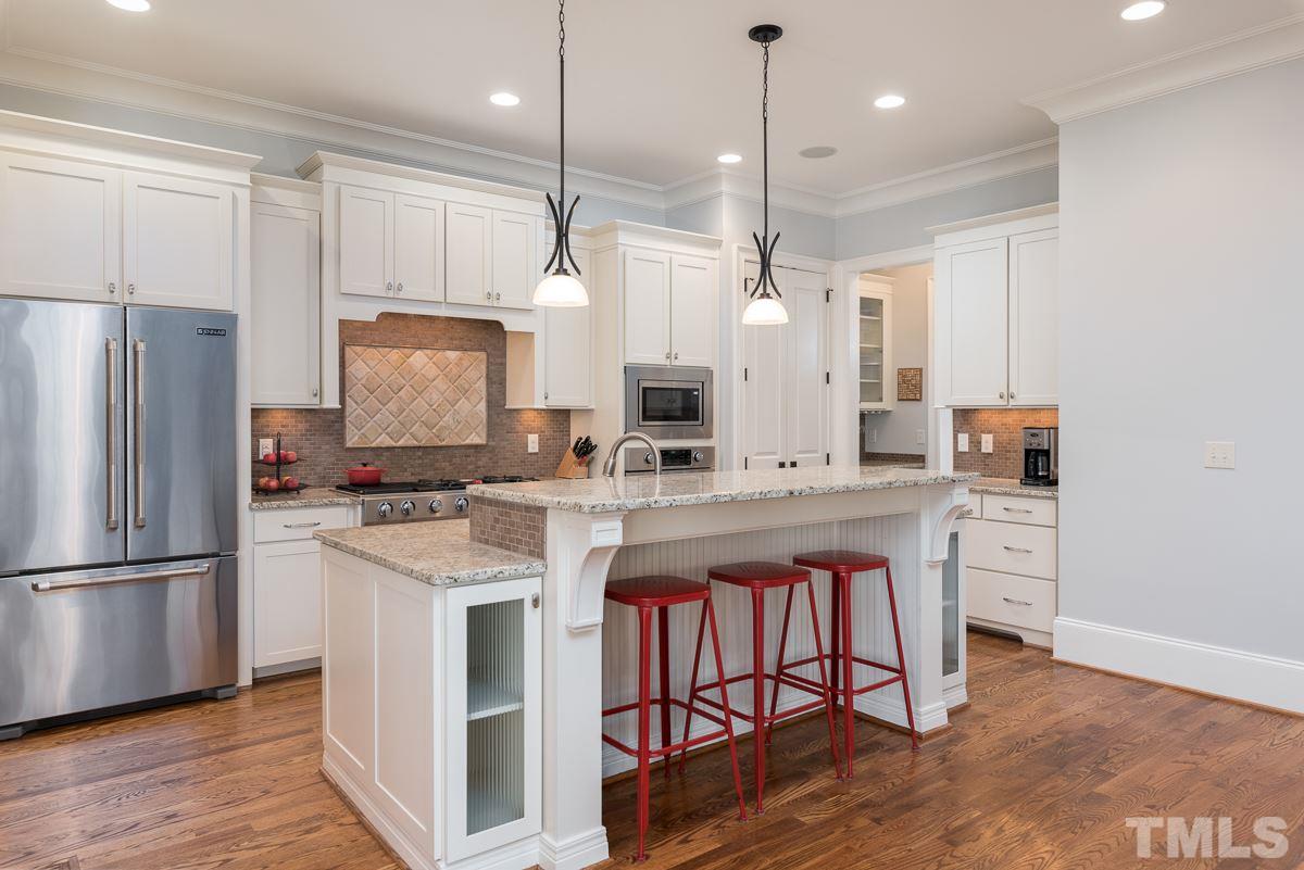 540 Guilford Circle Raleigh, NC 27608 - Photo 10 of 25 a kitchen with stainless steel appliances granite countertop a refrigerator a sink dishwasher a stove and white cabinets with wooden floor