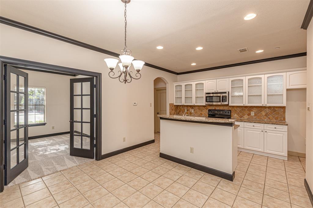 1871 Signal Ridge Place Rockwall, TX 75032 - Photo 2 of 26 a open kitchen with stainless steel appliances granite countertop a stove top oven and a granite counter top