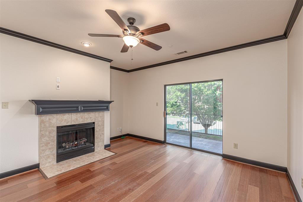 1871 Signal Ridge Place Rockwall, TX 75032 - Photo 6 of 26 an empty room with wooden floor fireplace and windows