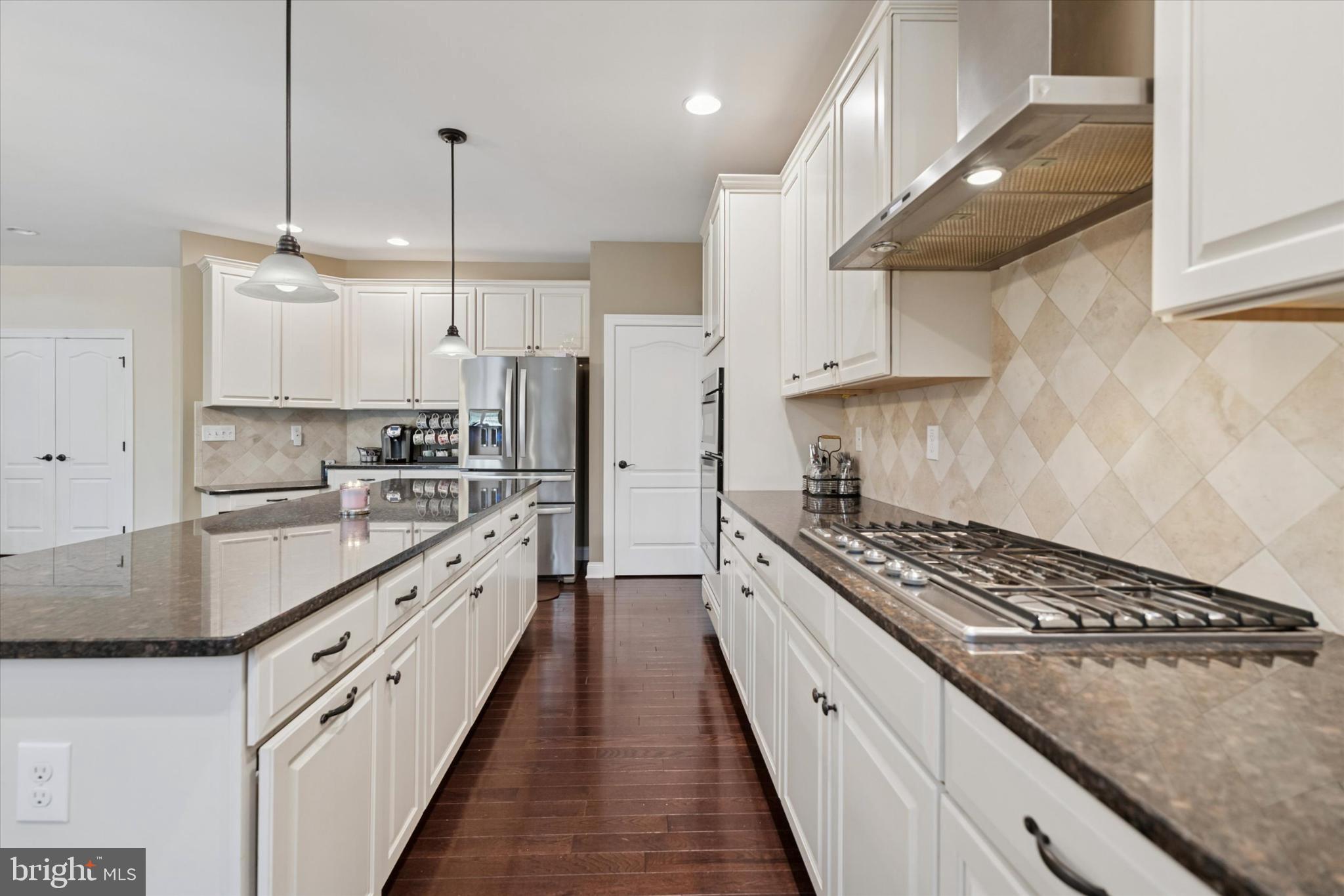124 Bennington Road Phoenixville, PA 19460 - Photo 14 of 54 a kitchen with stainless steel appliances granite countertop a stove a sink a refrigerator and white cabinets