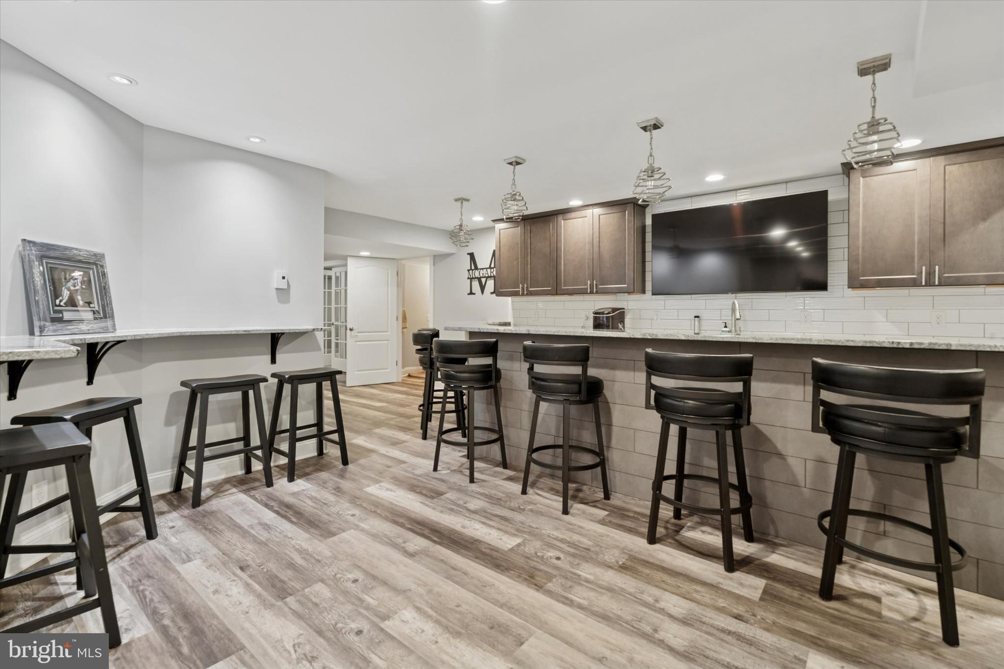 124 Bennington Road Phoenixville, PA 19460 - Photo 38 of 54 a kitchen with kitchen island a dining table chairs cabinets and wooden floor