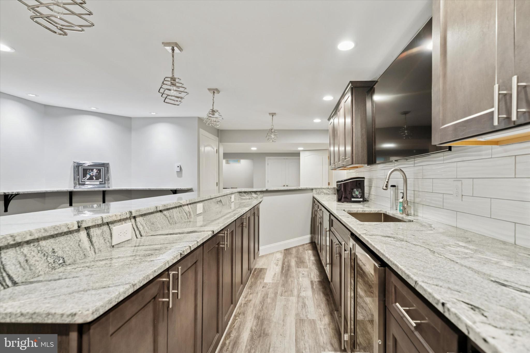 124 Bennington Road Phoenixville, PA 19460 - Photo 39 of 54 a kitchen with stainless steel appliances granite countertop a sink a stove and a wooden floors