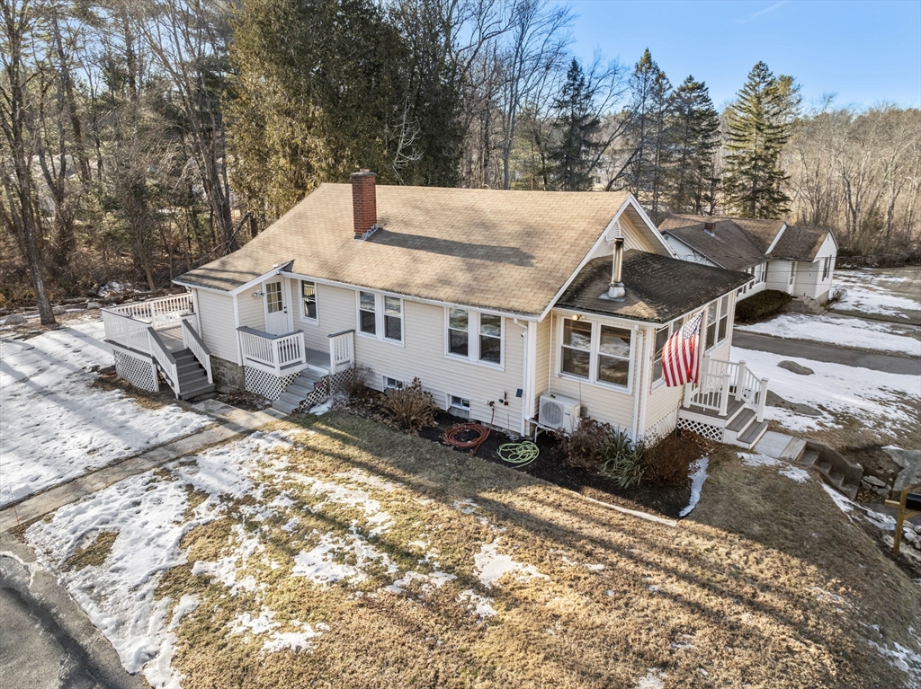 a view of a house with a yard covered with snow