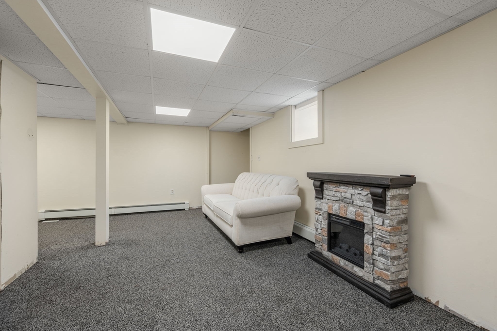 49 Metropolitan Avenue Ashland, MA 01721 - Photo 14 of 19 a living room with furniture and a fireplace