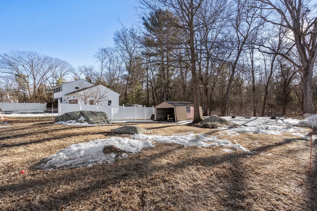 49 Metropolitan Avenue Ashland, MA 01721 - Photo 17 of 19 a view of a white house with a yard covered in snow