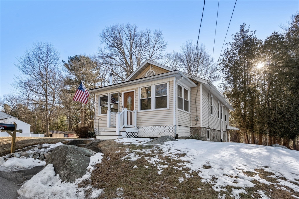 49 Metropolitan Avenue Ashland, MA 01721 - Photo 18 of 19 a front view of a house with a yard covered in snow